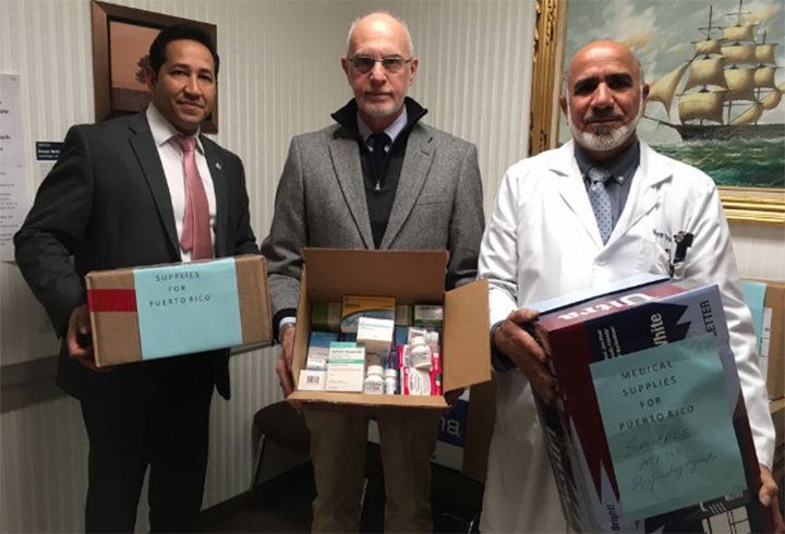Photo of State Rep. Carlos Gonzalez, D-Springfield, Dr. Martin Pion and Dr. Mohammad S. Bajwa hold medications that will be shipped to Puerto Rico this month to help an emergency clinic on the island.